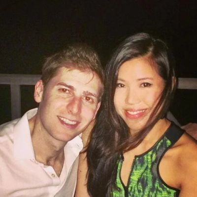 Elaine Andriejanssen is wearing a green dress whereas, Eduardo Saverin is wearing a white shirt.